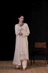 Woman wearing a cream embroidered kurta with cream-white pants