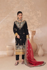 Woman in traditional embroidered black and gold embroidered outfit with red dupatta
