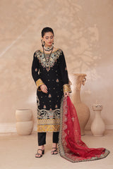 Woman in traditional embroidered black and gold embroidered outfit with red dupatta