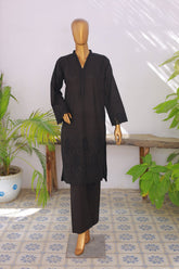 Mannequin wearing a black outfit with a white wall and plants in the background
