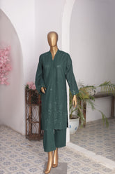Green embroidered outfit on a mannequin against a white wall with decorative elements.
