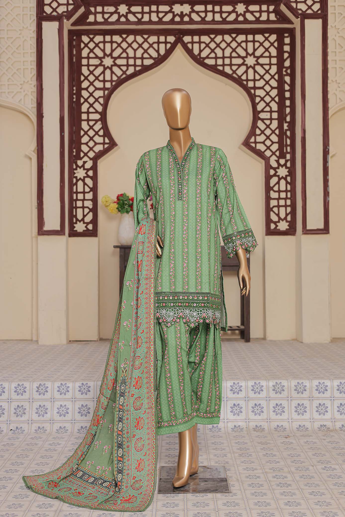 Green embroidered traditional outfit on a mannequin against an ornate wall.