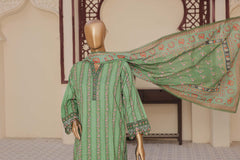 Green patterned dress on a mannequin with a matching scarf draped over it, against a neutral background.