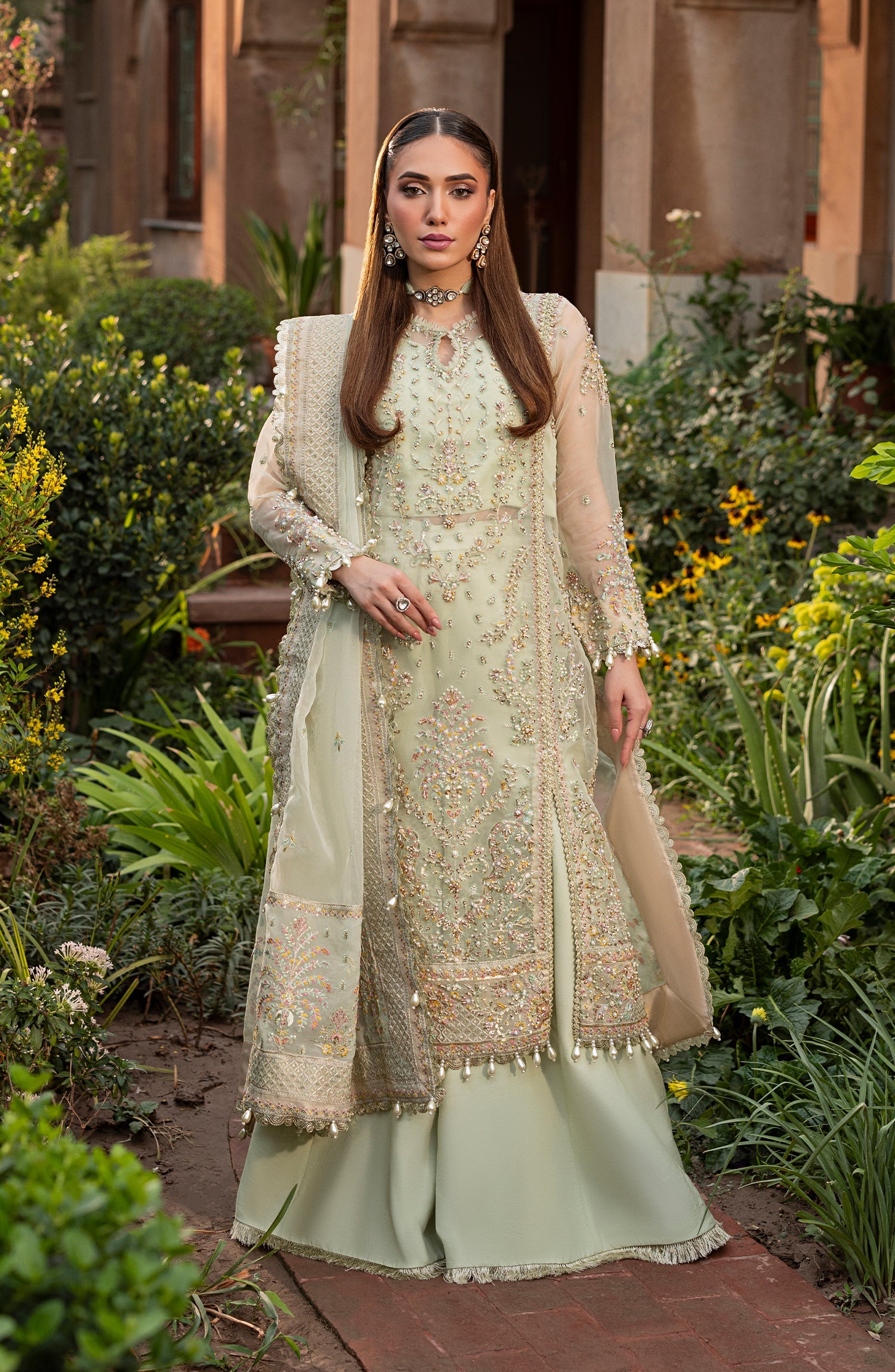 Model front look wearing Aylin Sage formal dress in light green shade