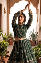 Fashion model dressed in Aylin emerald maxi with elegant flowy design