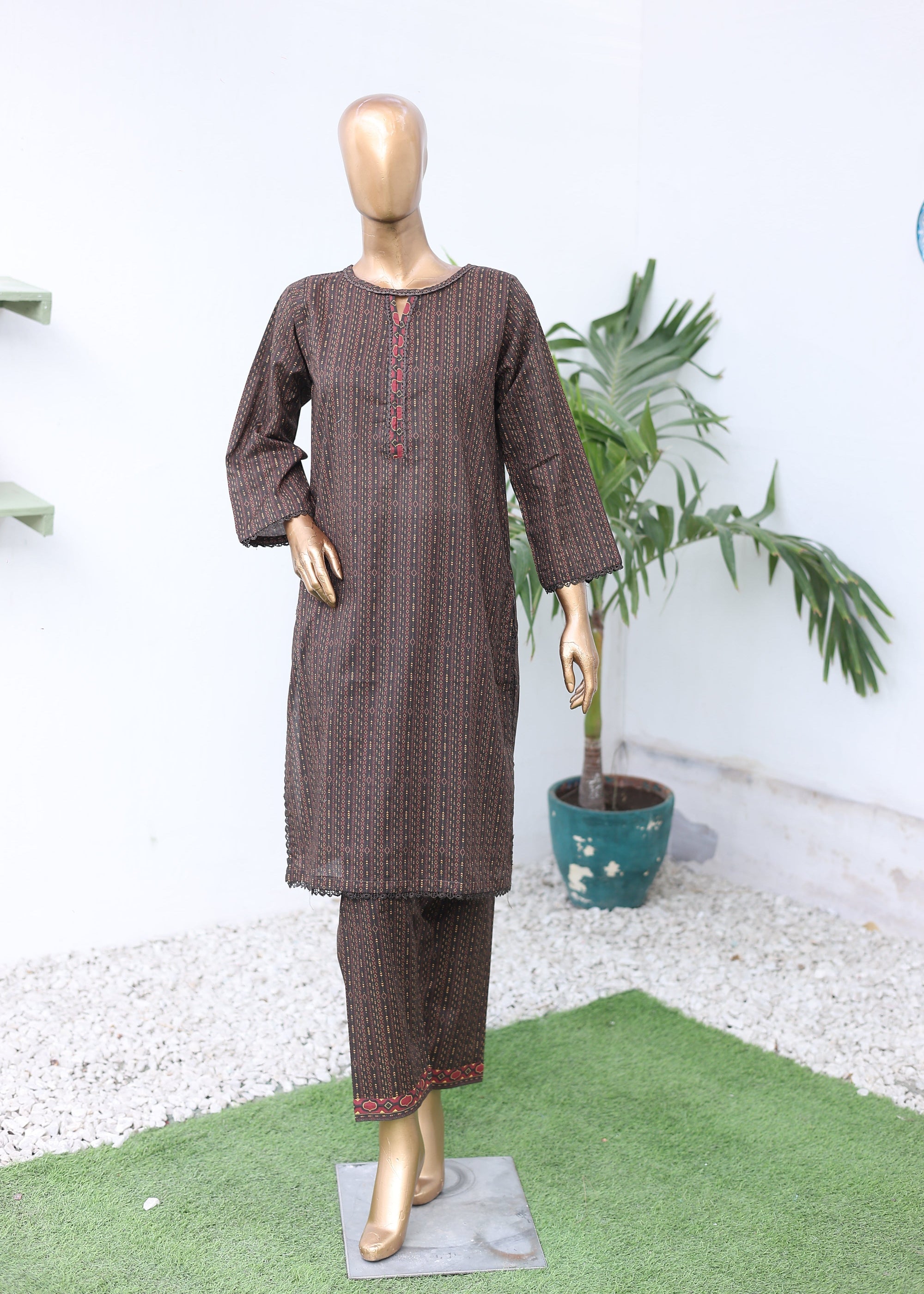 Mannequin wearing a brown outfit with a white background