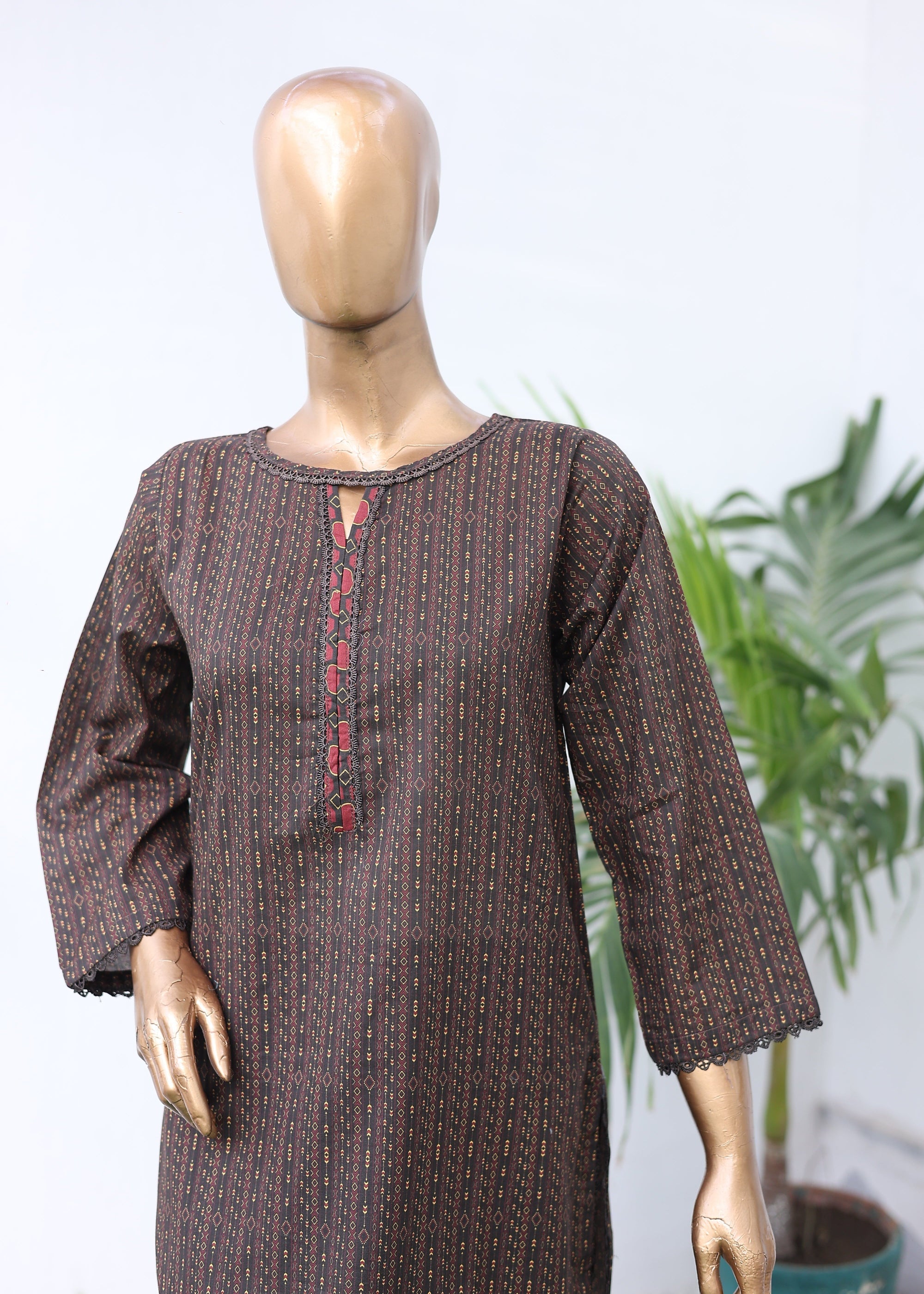 Mannequin wearing a brown textured outfit with a blurred background