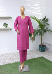 Mannequin wearing a pink outfit with a plant on a white floor.