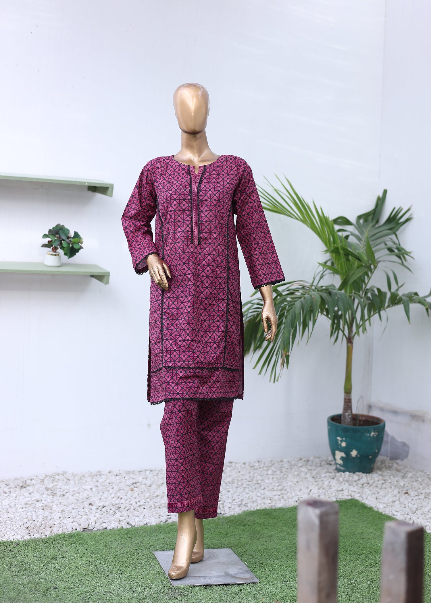 Mannequin wearing a purple outfit with a white background and plants.