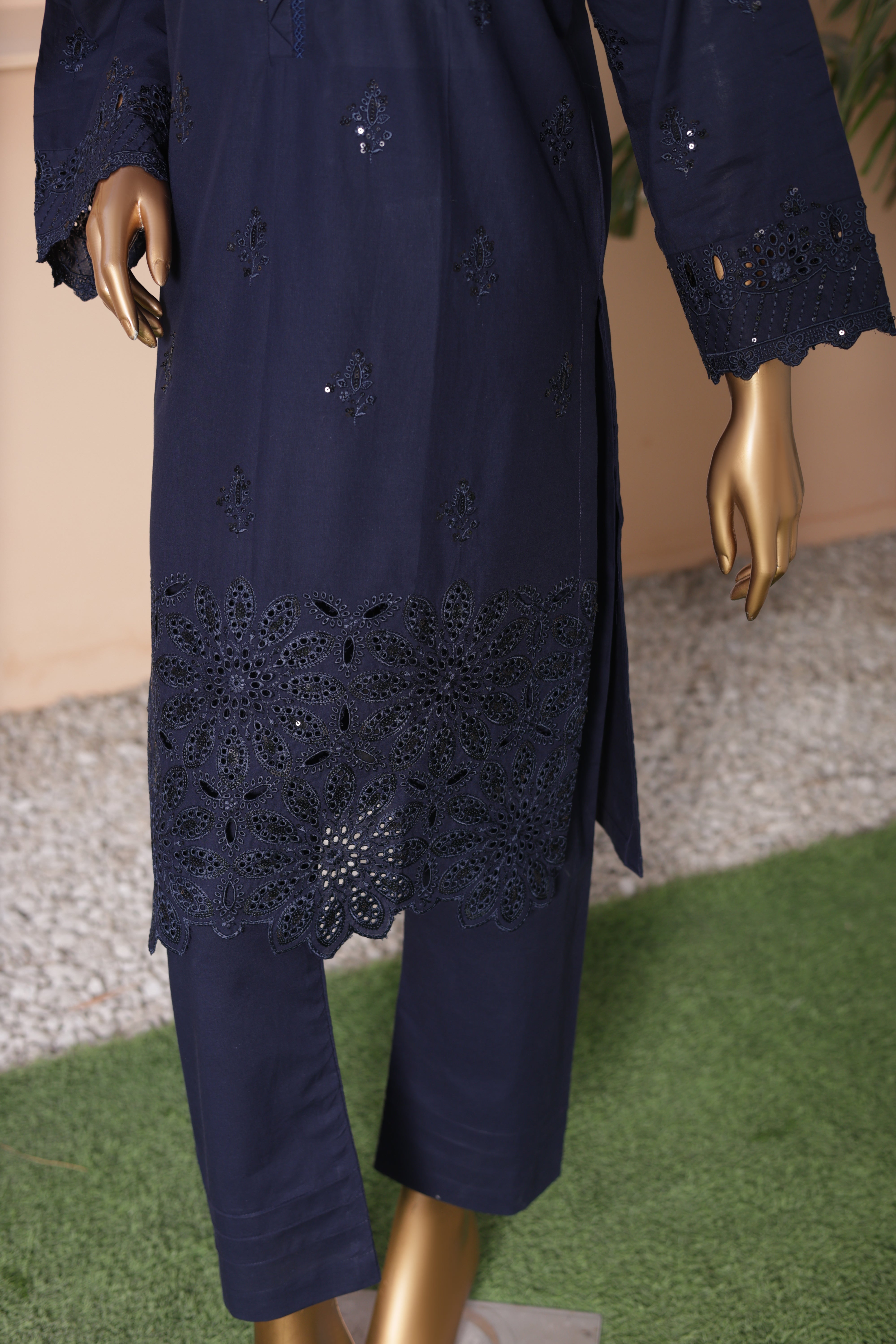 Navy blue embroidered outfit on a mannequin with a neutral background