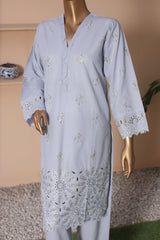 Light blue embroidered dress on a mannequin against a neutral background