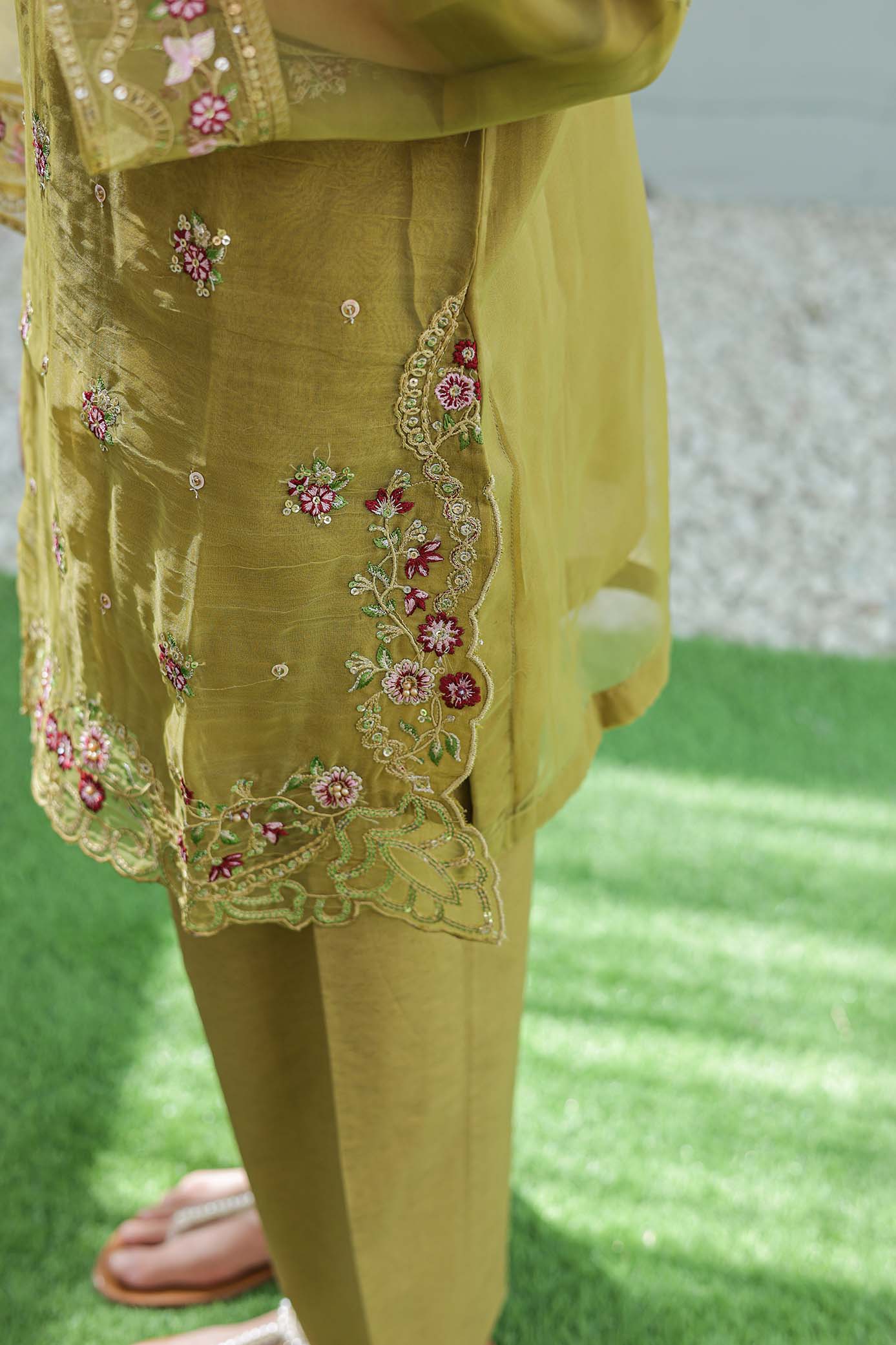 Yellow embroidered outfit on a green surface